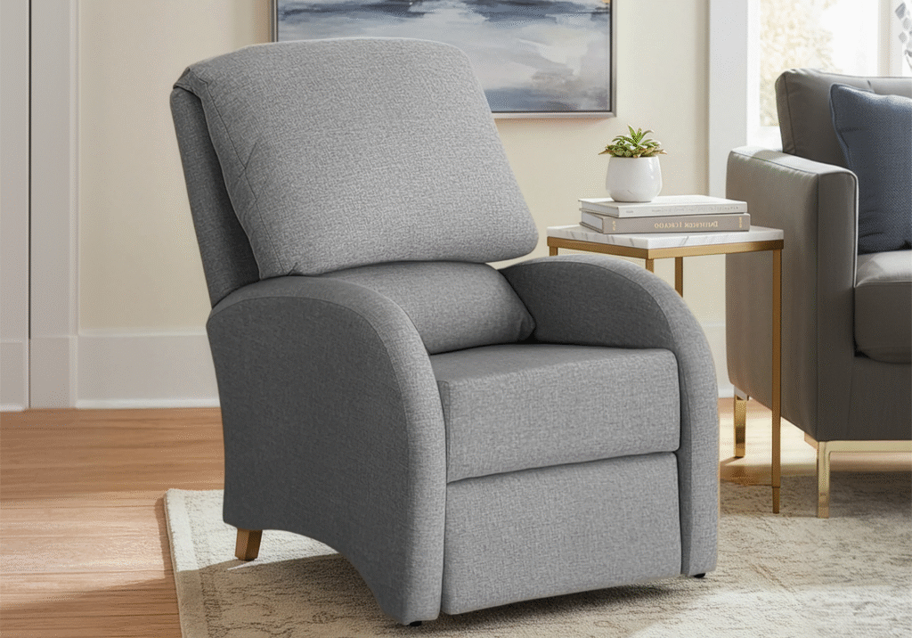 Poltrona Ricoleta centralizada em sala confortável e bem iluminada, posicionada sobre tapete, ao lado de banqueta com livros e uma planta.